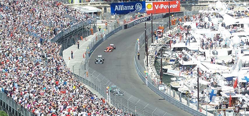 2 f1 cars competing round a corner at the monaco gp