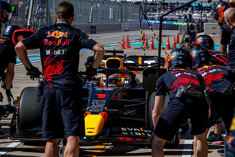 red bull team taking car of their f1 car in the pits