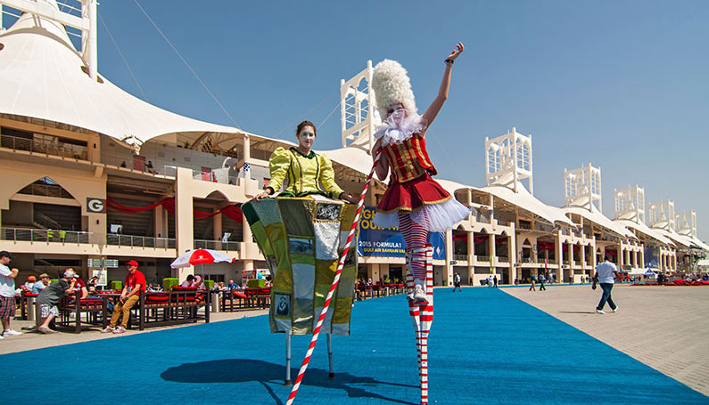 performers on stilts at the bahrain gp race track