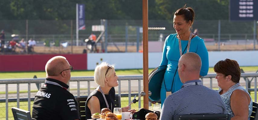 waitress serving f1 guests at a table