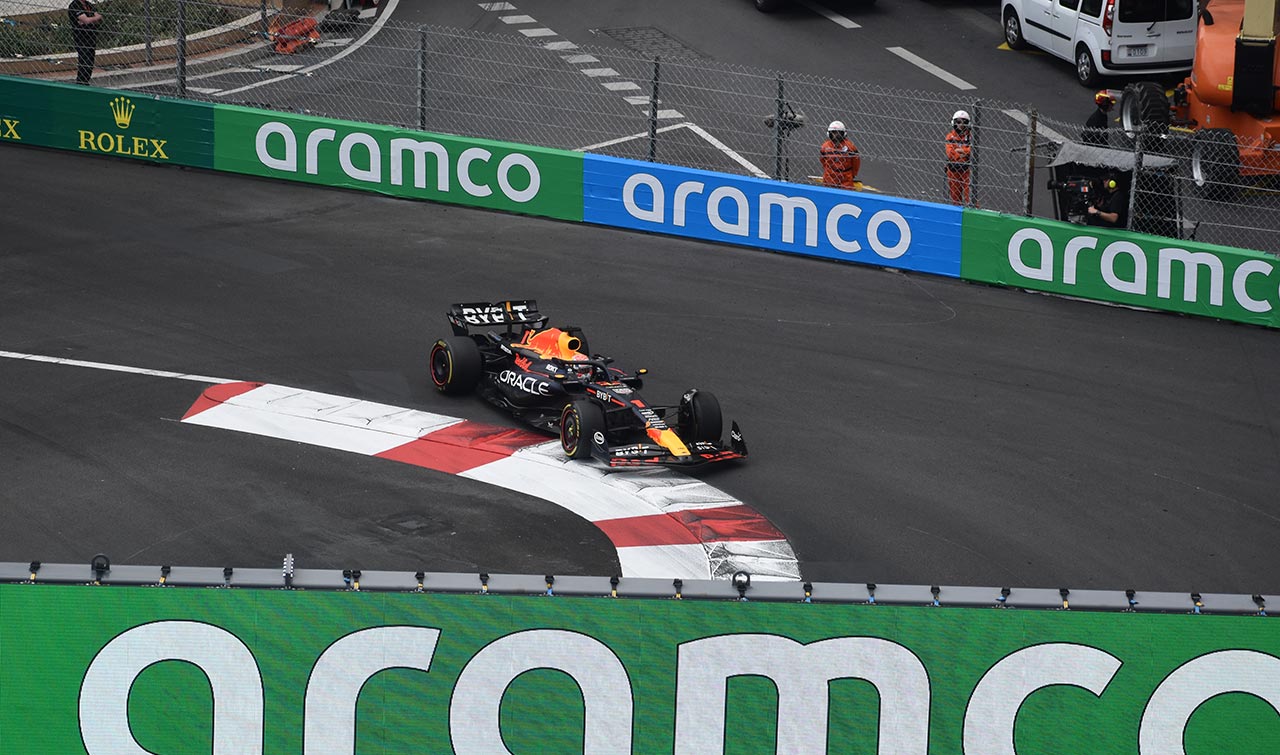 max verstappen in his red bull f1 car steering round the first corner in monaco
