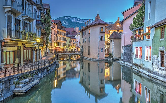 annecy town with houses on either side of the river