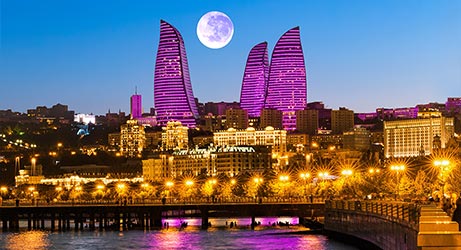 night city view of baku with moon in the sky