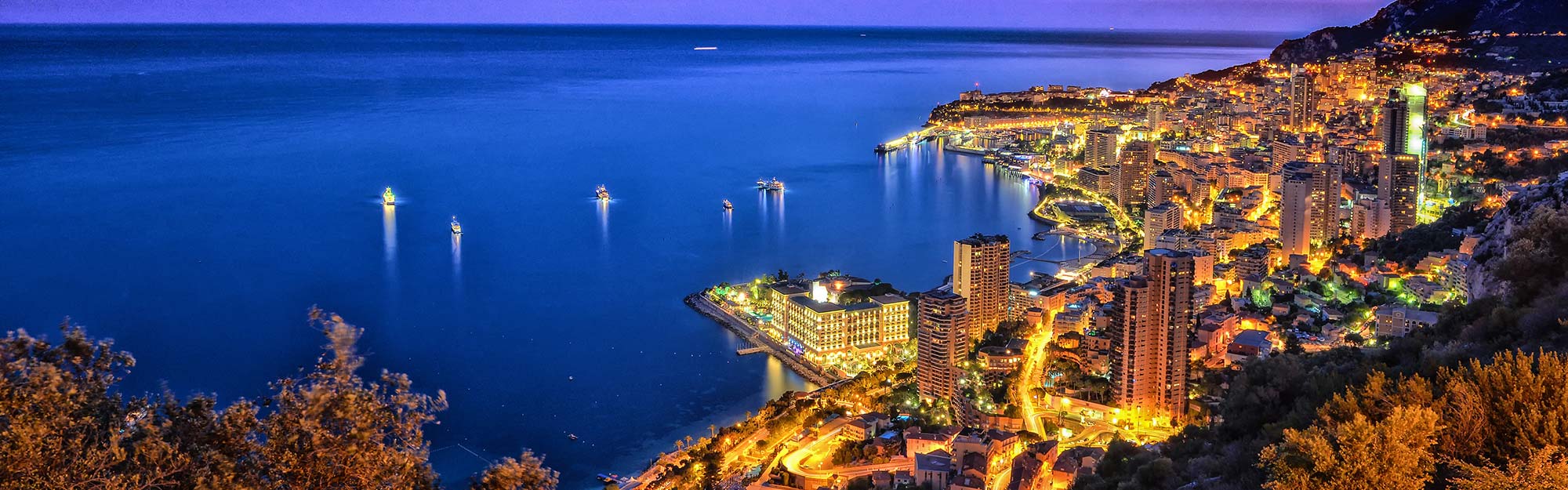 view from the hills overlooking monaco and the bay at night