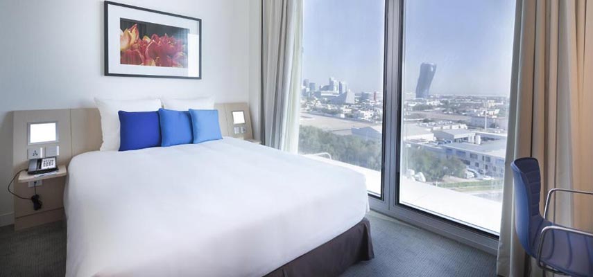 double bed with views of abu dhabi