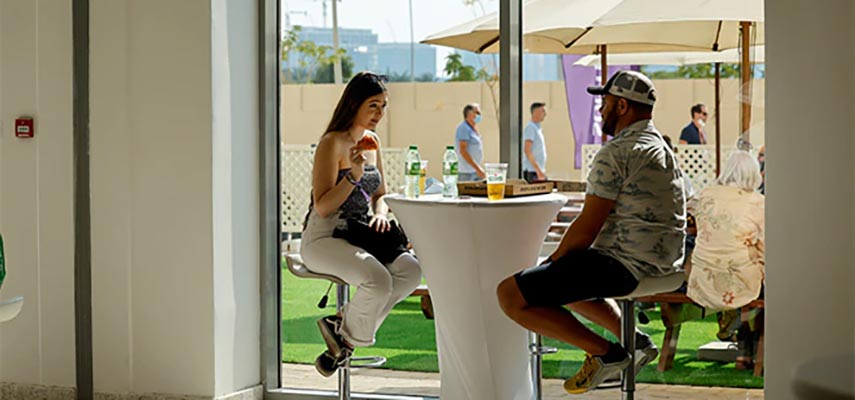 couple sitting at a table at the abu dhabi gp
