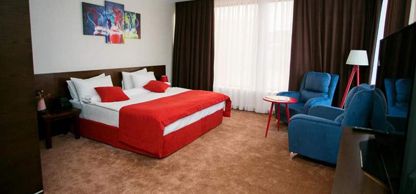 double bedroom with red covering