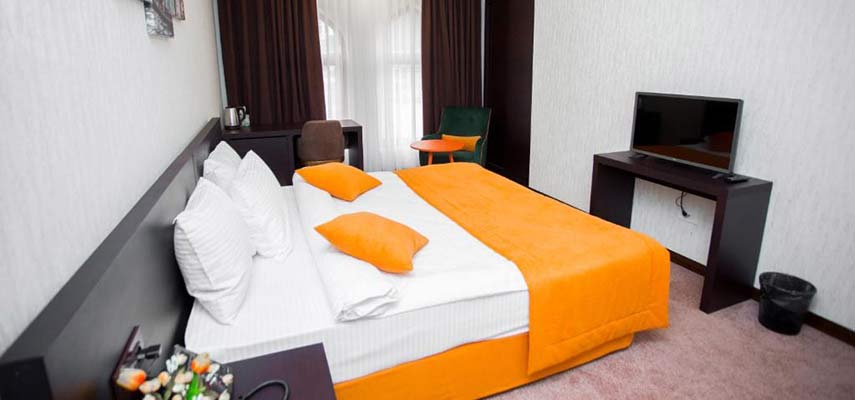 double bedroom with orange covering