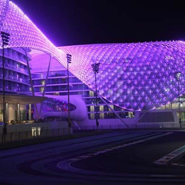 yas marina hotel all lit up in purple