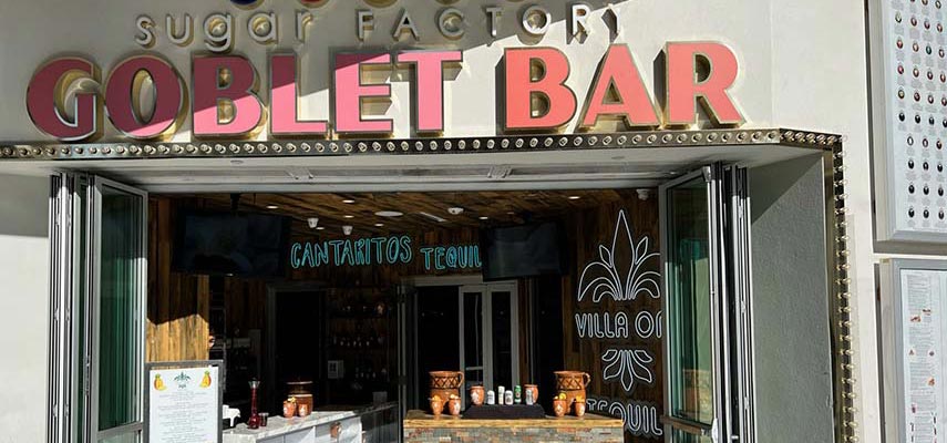 entrance to a restauarant that says Goblet Bar and the sugar factory