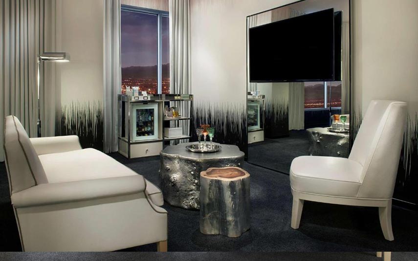 hotel room lounge with tv chairs and minibar