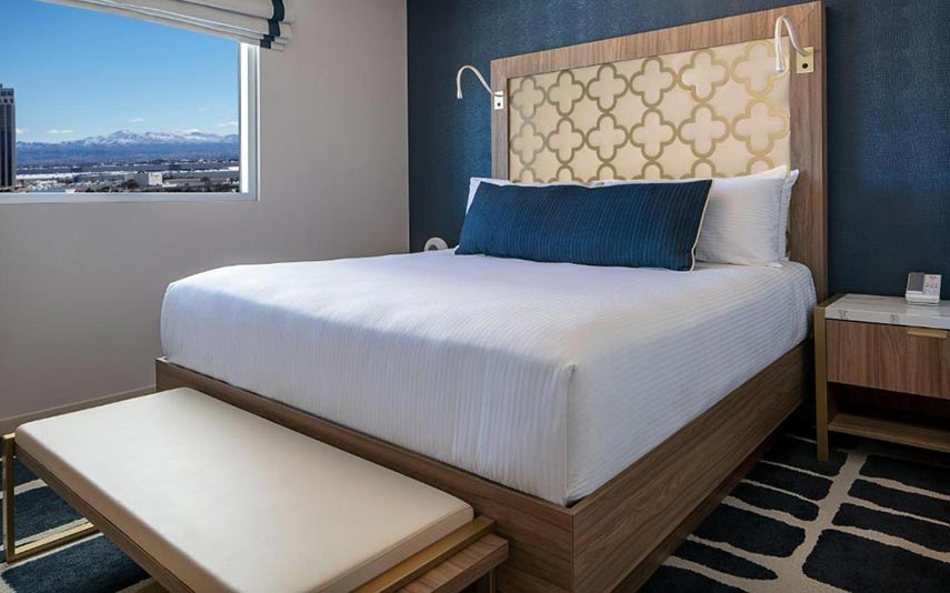 double bedroom with views of the mountains in the distance from the window