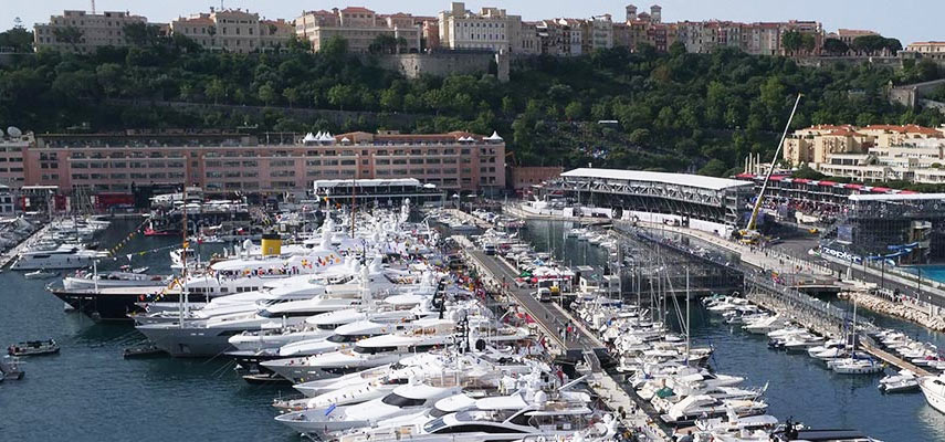 luxury yachts in the harbour looking to monaco castle on the hill