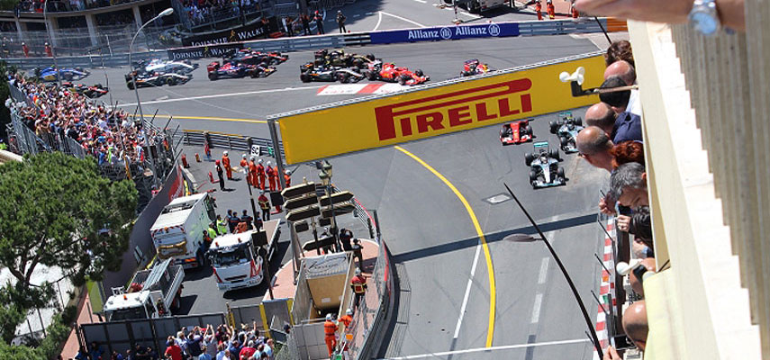 many f1 cars turning a corner at the race