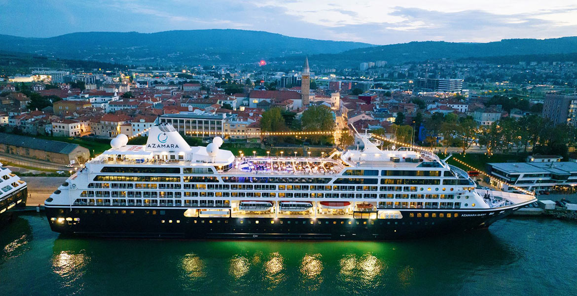 cruise liner berthed at the dockside with views of the town in background