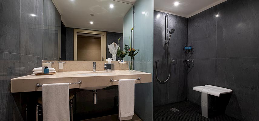bathroom with double sink and shower room