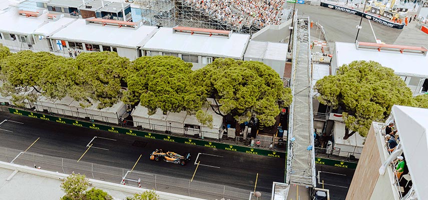 view of the monaco race track from above with an F1 car racing by