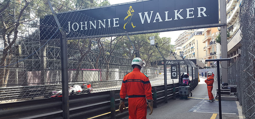 johnnie walker sign, f1 car and support staff