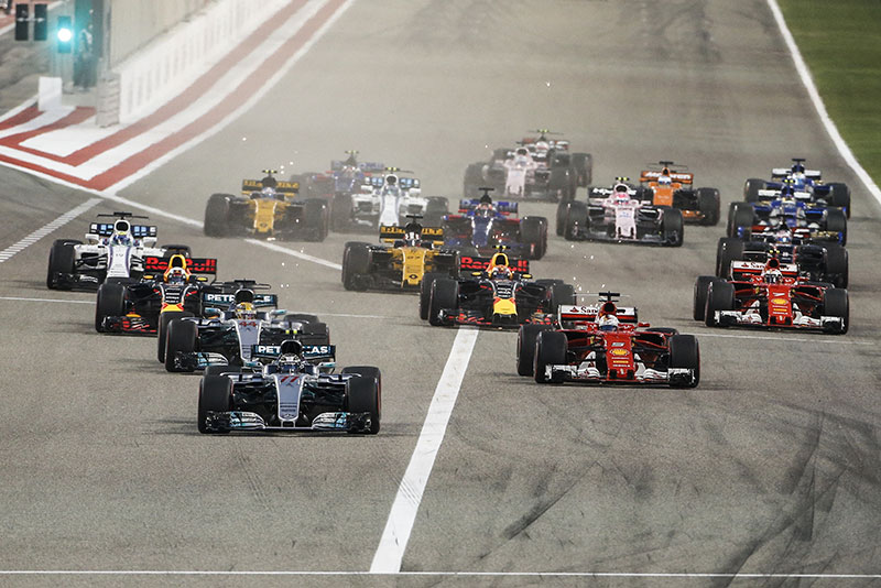 multiple f1 racing cars competing at the bahrain gp