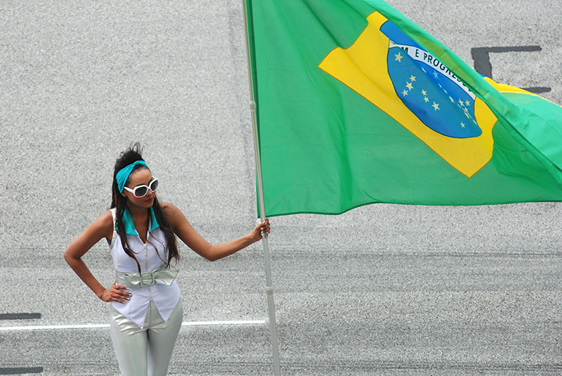 women holding a brazilian flag