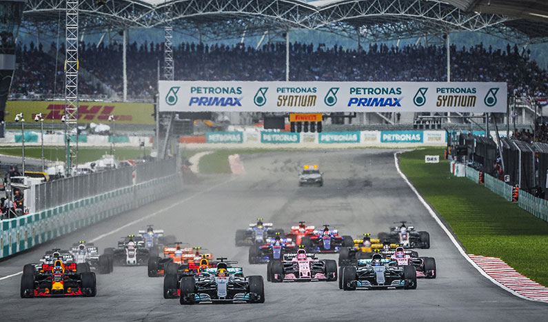 big group of f1 cars racing on the track