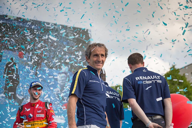 retired f1 driver alain prost smiling with tickertape coming down