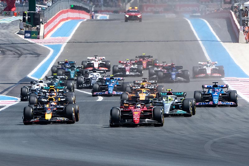 the pack of f1 cars racing at the french gp