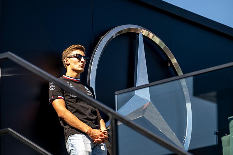 f1 driver george russell with mercedes logo in the background