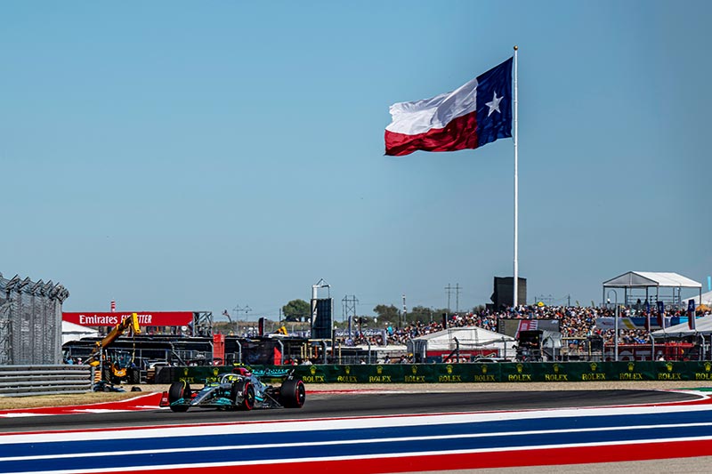 mercedes team formula one car with texas flag flying