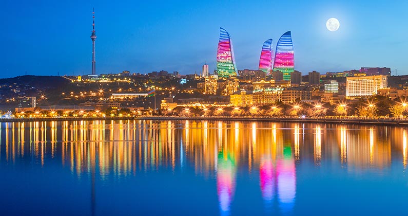 moon over the flame towers in baku city