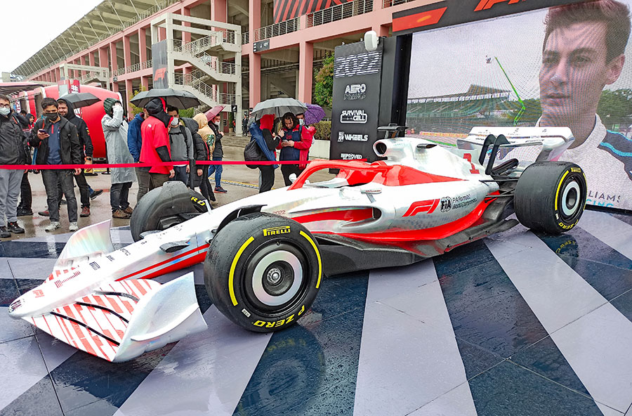 a new f1 car out on display for the new 2022 season with driver george russell on the tv