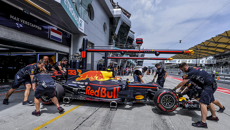 red bull racing car in the pits with the team