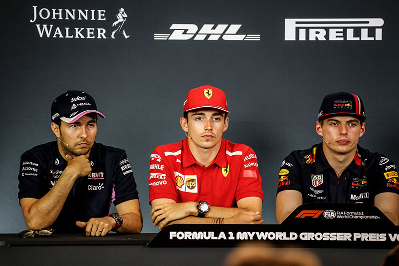 3 drivers talking at a press conference after the race