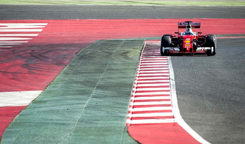 lone f1 car racing down the track in spain