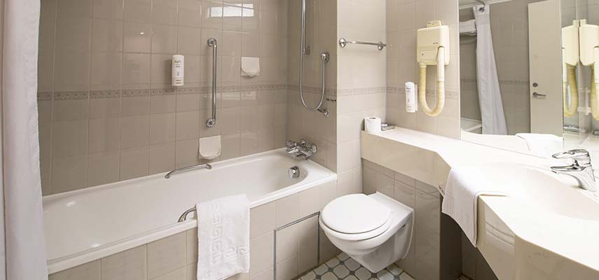 hotel bathroom with bath and toilet