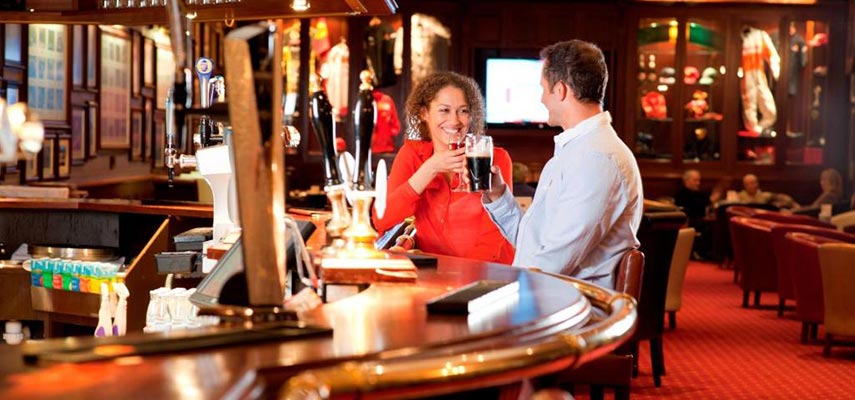 couple sitting at a bar enjoying a drink