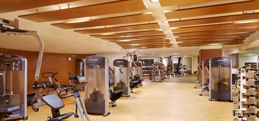 exercise room with exercise machines and selection of dumbells
