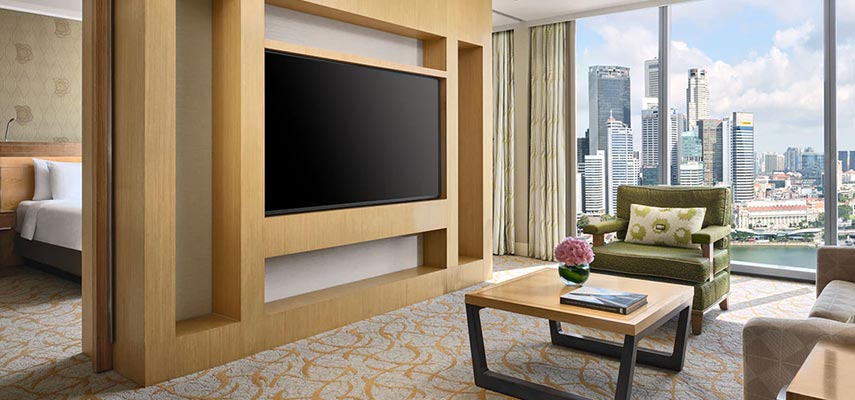 chair, coffee table and large TV, with view of Singapore business district